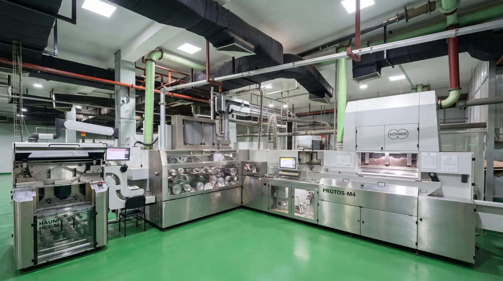 A high-speed cigarette making line on a factory floor